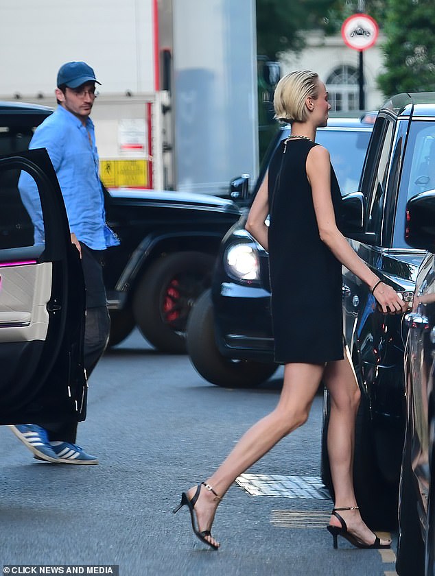 The model accessorized with a simple diamond necklace and slicked back her blonde locks in a wet style.