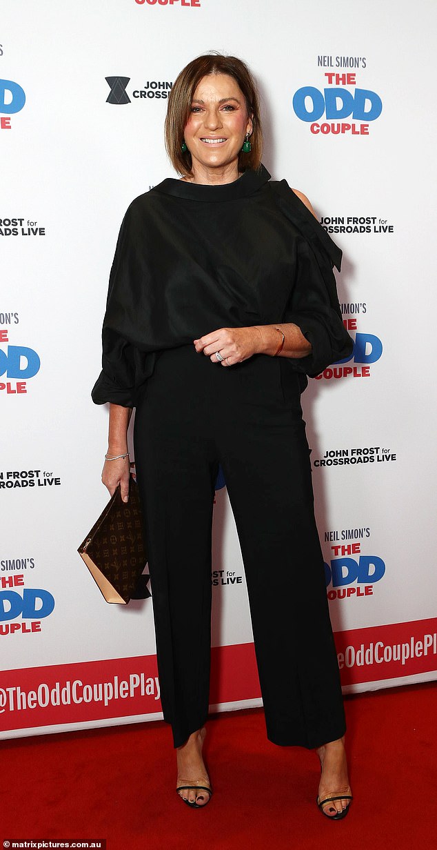 Sporting a very glamorous makeup look, the breakfast show host tucked a chic off-the-shoulder blouse into a pair of black straight-leg trousers.