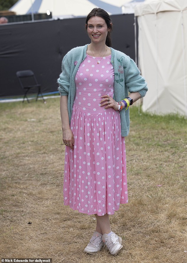 The singer looked gorgeous in a pink polka dot dress and a green cardigan.