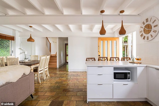 The villa's kitchen features charming slate tiles and a comfortable dining and living room area.