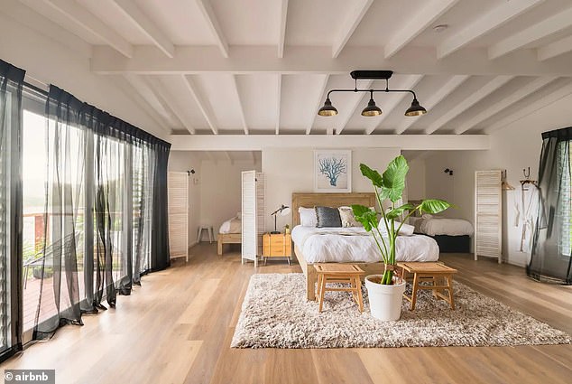 The elegant upstairs loft bedroom has beautifully appointed nooks with private sleeping areas.