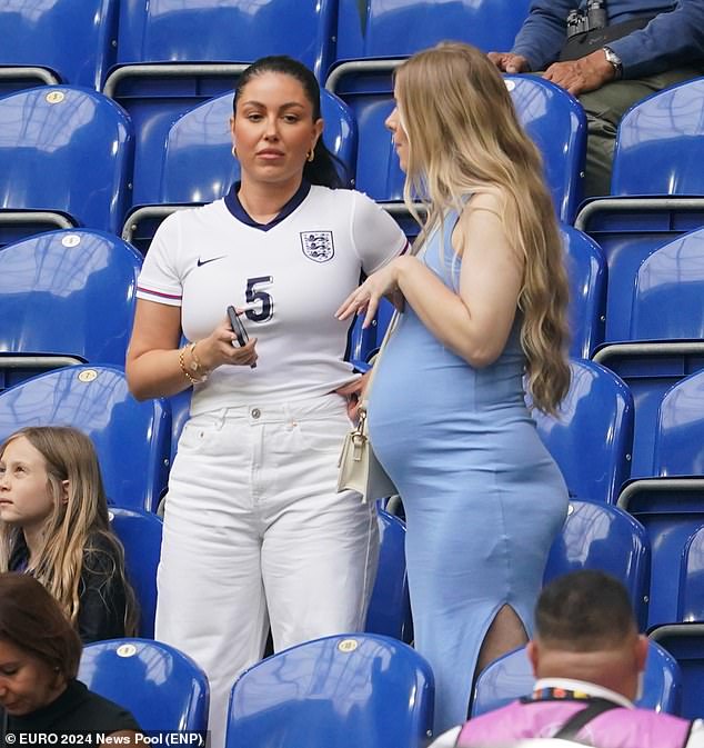 Olivia Naylor, the girlfriend of defender John Stones, chatted to another spectator before the match.