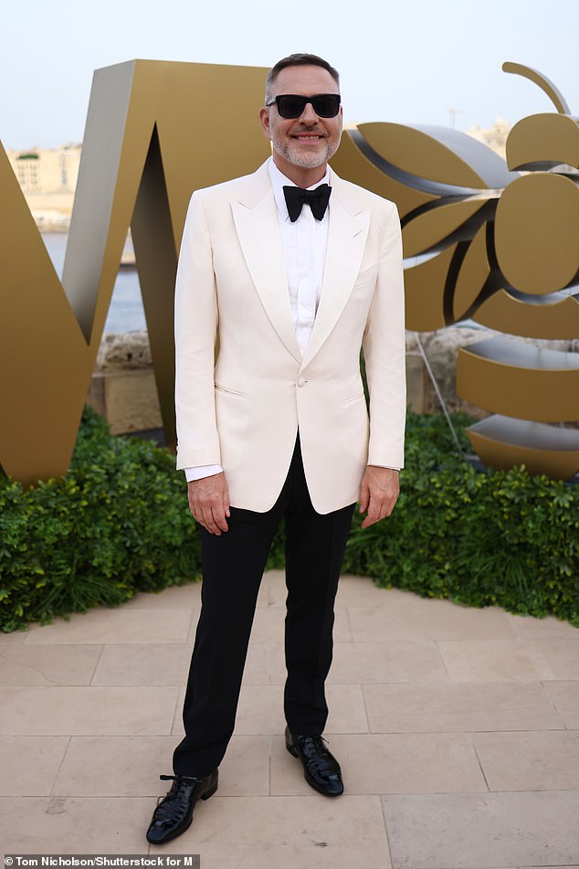 The comedian, 52, did his best to look his best in a cream tuxedo jacket and a big black bow tie, with a white shirt underneath and a pair of black pants.