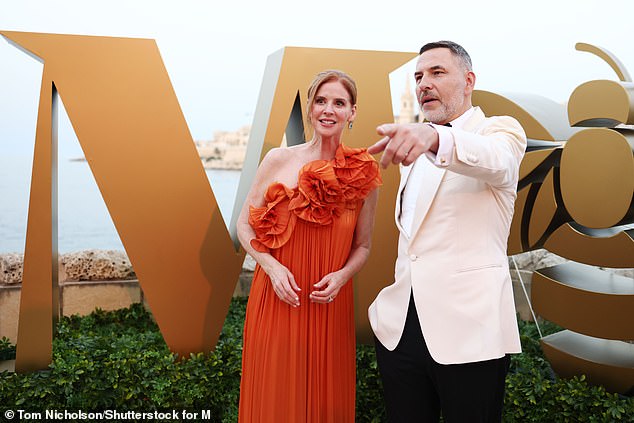 While Sarah, 51, made sure all eyes were on her as she arrived in a one-shouldered orange satin dress, with a floral ruffle at the neckline.