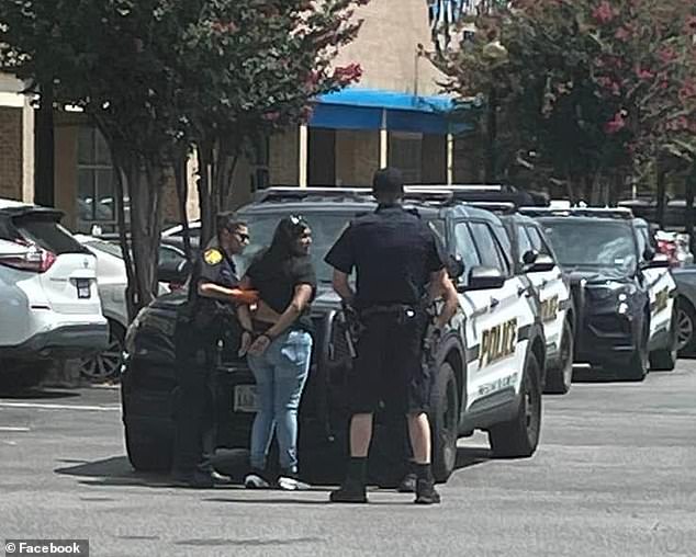 It's unclear which store she entered, but according to Valezquez, the mother said she left the car running and that her boyfriend was in the car with the children. (pictured: Garza-Amador being handcuffed at the scene)