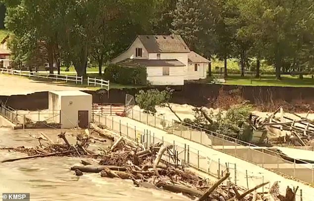 The house Barnes' father still lives in is at risk of being swept away by a flood after the dam came in. 