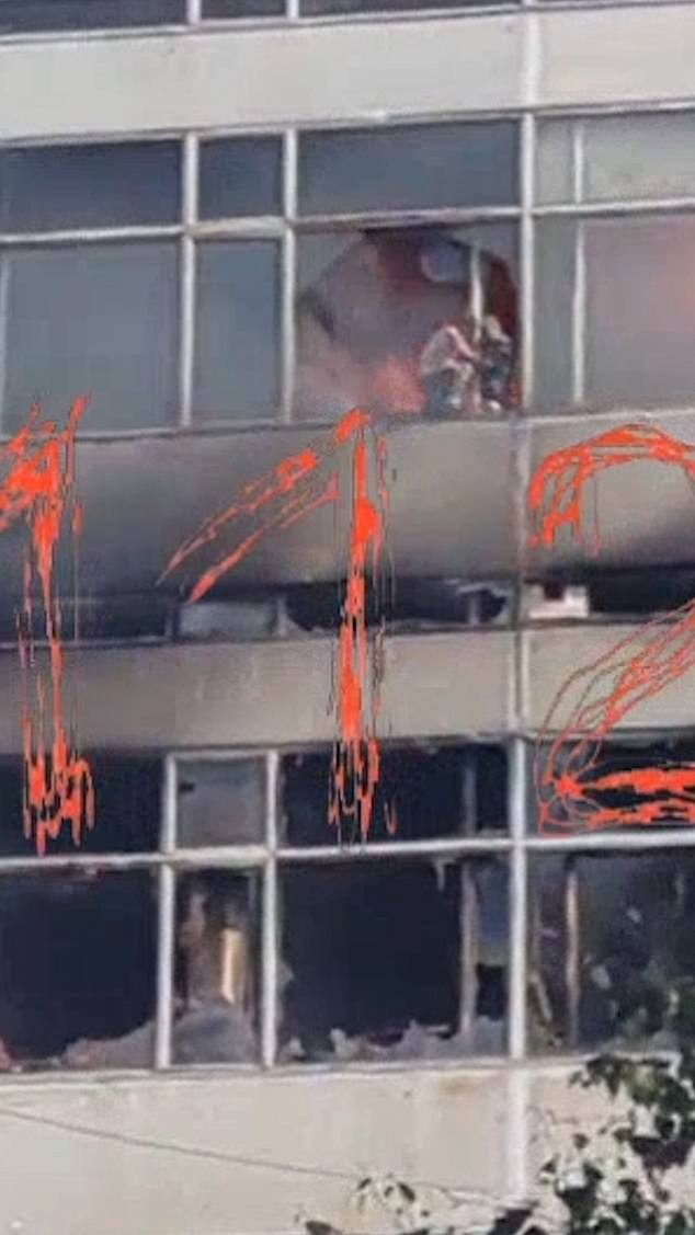 Disturbing footage shows people on building window sill before jumping