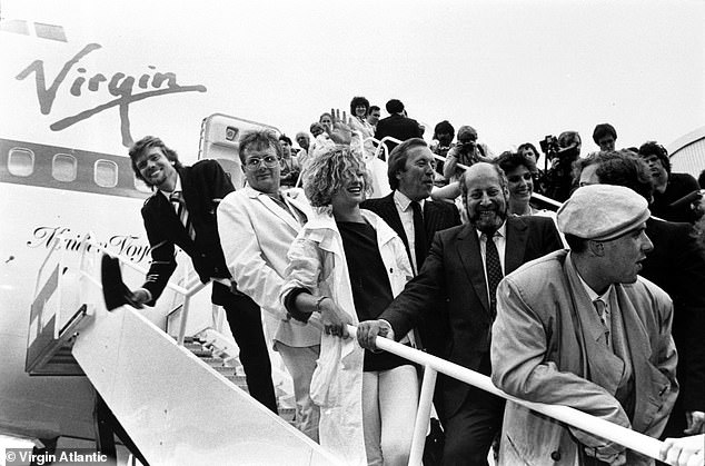 Virgin Atlantic's first flight in 1984, from London Gatwick to New York, with passengers disembarking from Sir Richard's Boeing 747-200 at Newark Liberty International Airport.