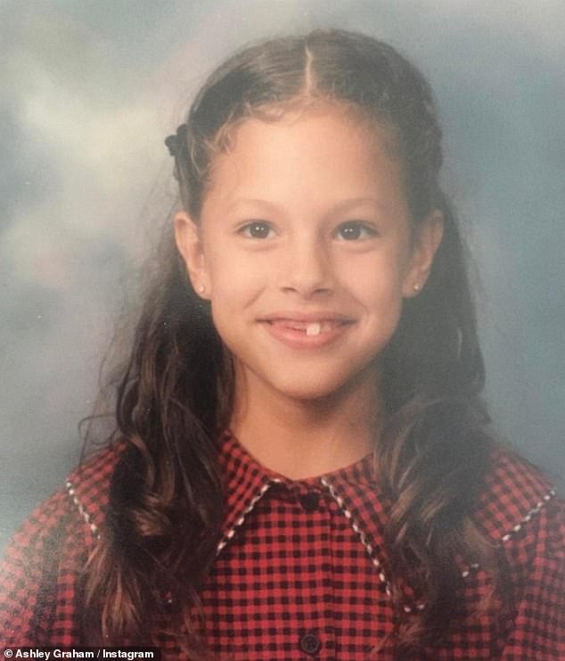 Graham as a young schoolgirl in a red dress and diamond earrings.