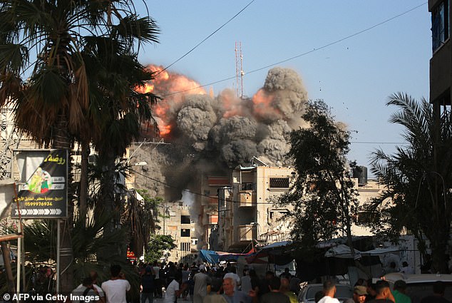 A ball of fire and black smoke rises moments after an Israeli airstrike targeting a residential building in the town of Bureij, central Gaza Strip, June 3, 2024.