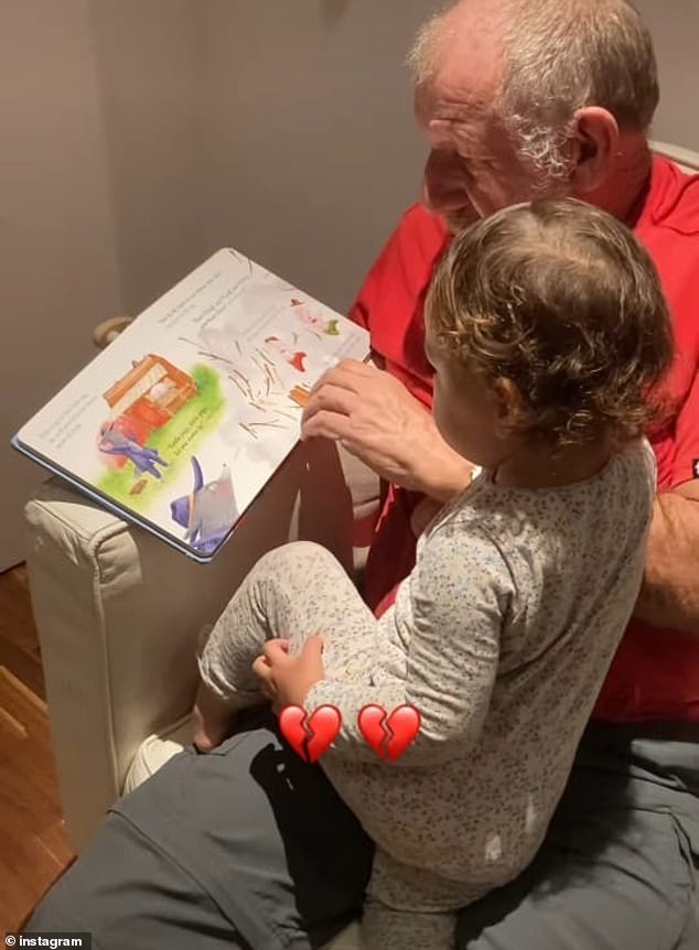 Bernard appears in the photo reading a bedtime story to his granddaughter.