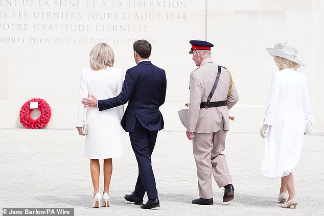 President Macron put a supportive arm around his wife as they joined King Charles and Camilla at the memorial.