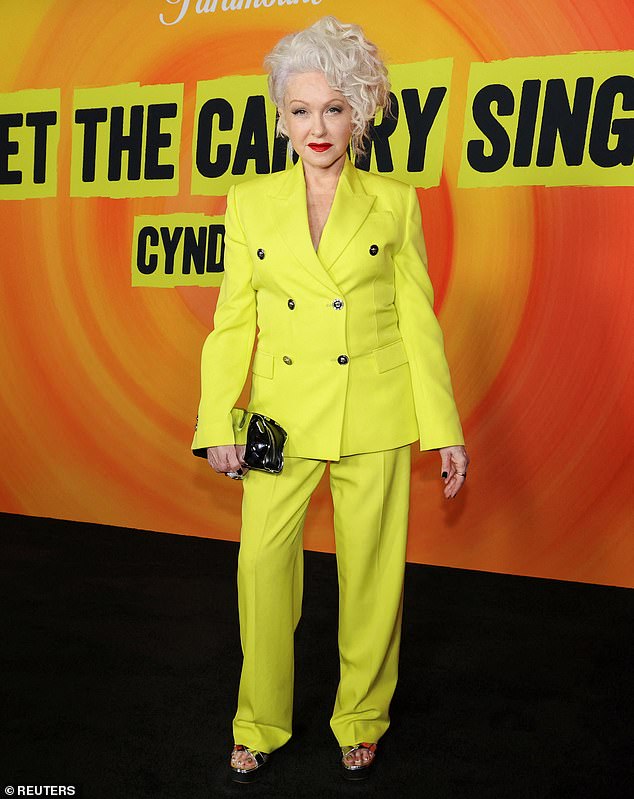 The Time After Time hitmaker looked radiant in a striking canary yellow double-breasted suit.