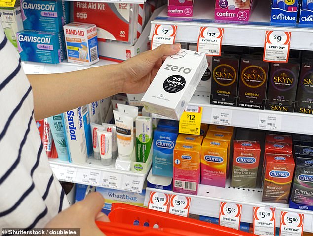 The co-owner of the pharmacy explained that all contraceptive items, including condoms, were not sold in the store (pictured, a shopper chooses condoms in the healthcare aisle at Coles).