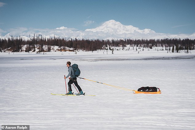 Oli met up with a mountaineering team and hiked 75 miles (122 kilometers) to reach Denali Base Camp. He is pictured above walking through the hills to base camp.