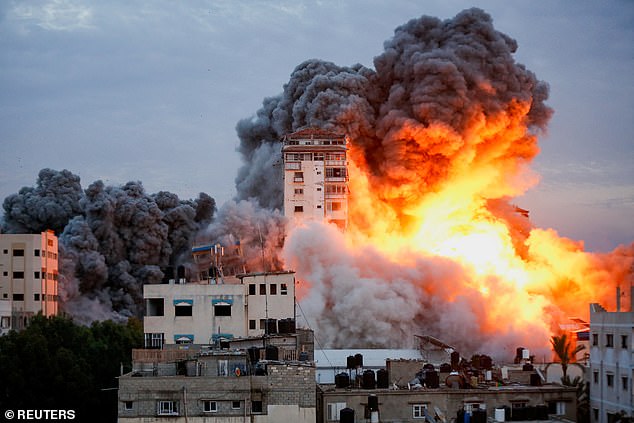 Smoke and flames rise after Israeli forces attack a high-rise tower in Gaza City, October 7, 2023.