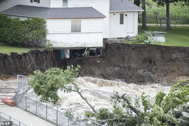 The house, which operated a local store for decades, teetered on the edge of the Blue Earth River when the Rapidan Dam began to fail before erosion destroyed its foundation Tuesday.