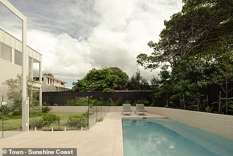 Outside, the outdoor entertaining area overlooks the in-ground saltwater pool surrounded by an invisible glass fence, a sun lounging area and a lush grass area.