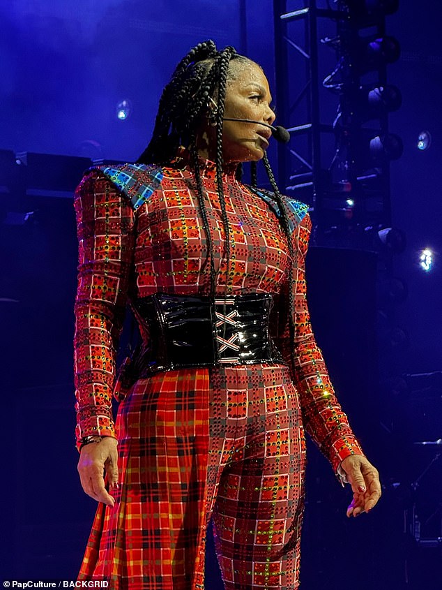 An outfit change saw the pop icon re-emerge in a red plaid jumpsuit with a corset-style black patent leather belt that gave more definition to her waist.