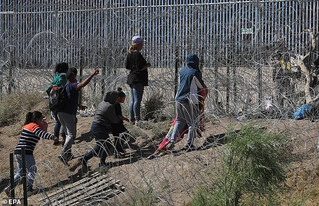 It comes after years of pressure from Republicans demanding measures to quell the southern border crisis and just five months before the November elections. In the photo: Migrants wait between Mexico and El Paso, Texas, to request asylum in the US.