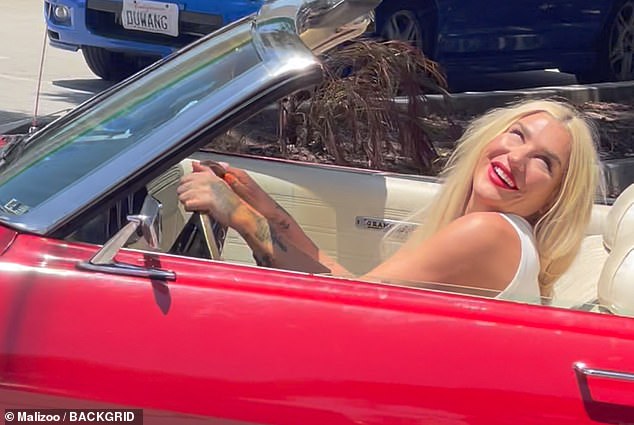 The Die Young singer was smiling on a summer day in Southern California behind the wheel of a red convertible.