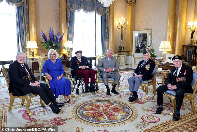 Charles and Queen Camilla pose for a photograph alongside D-Day veterans Arthur Oborne, Jim Miller, Bernard Morgan and John Dennett.