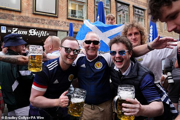 Fans were seen waving Scottish flags and scarves ahead of tonight's game against Germany.