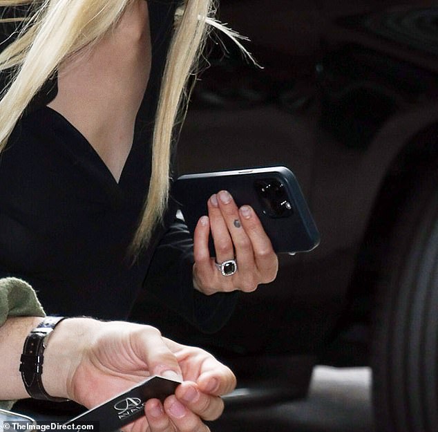 His wife-to-be showed off her huge £10,000 black diamond ring on her ring finger as they stepped out in New York City together, just hours after revealing their happy news on Instagram.