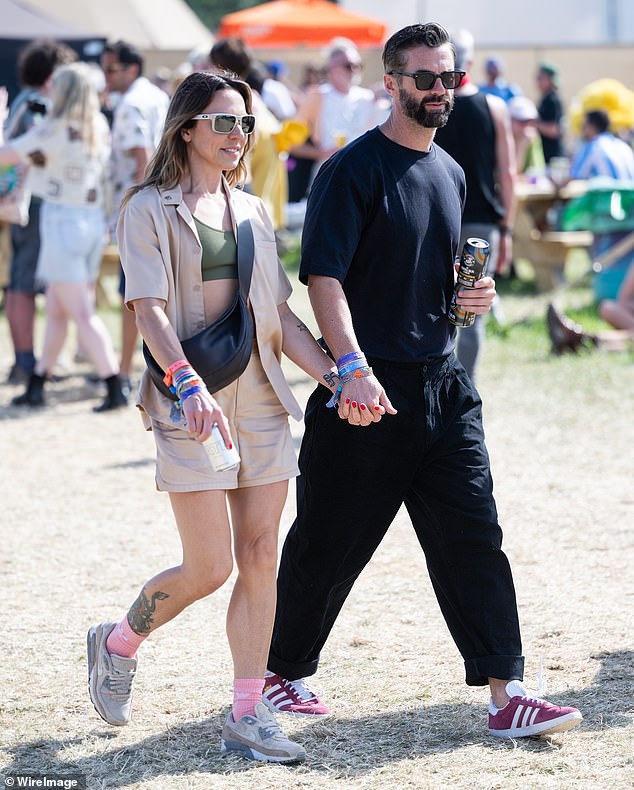 The couple looked happier than ever as they held hands and carried drinks in each other's hands as they toured the iconic Worthy Farm.