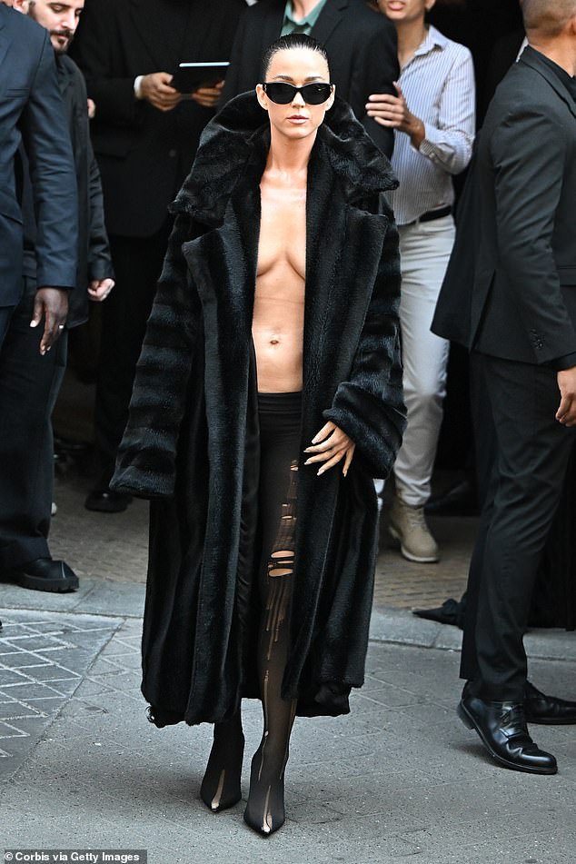 Katy Perry showed off her most daring look yet when she arrived at the show in a dangerously plunging fur coat.