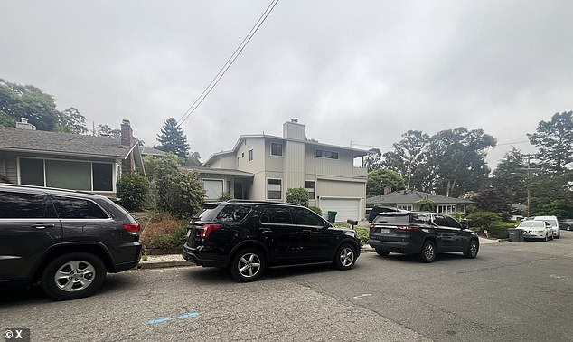 A photo of his house on Maiden Lane is seen surrounded by multiple unmarked black vehicles parked on the street.