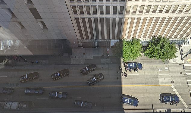 Police vehicles could be seen lining up in front of the FBI building in Seattle as they dealt with a woman who was armed.