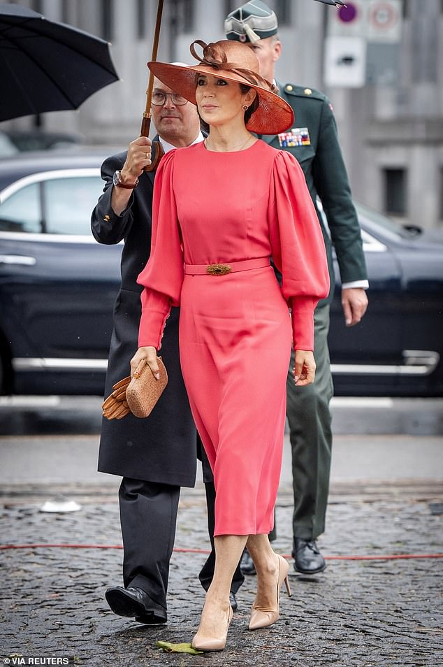 The 52-year-old has worn the coral hat twice, but struggled to keep it on her head when faced with an unexpected breeze.