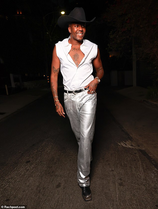 Vas, 35, bared his tattooed chest in an unbuttoned white shirt, paired with trendy metallic silver jeans.