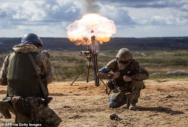 Ukrainian soldiers fire a mortar during military training with French soldiers in Poland, April 4, 2024.