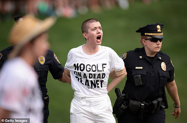 Protesters storm the 18th green during the final round of the Travelers Championship