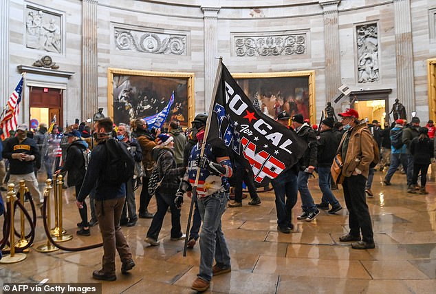 Supporters of US President Donald Trump wander under the Capitol Rotunda after invading the Capitol building on January 6, 2021.