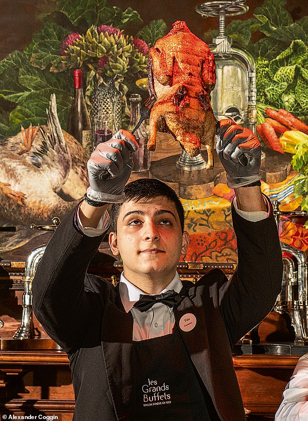 One of the waiters holds a canard au sang or pressed duck