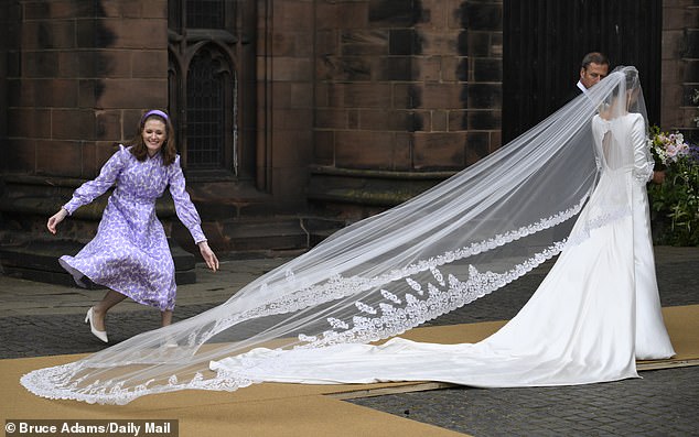 Olivia's stunning wedding dress featured a partially open back as she arrived at Chester Cathedral.