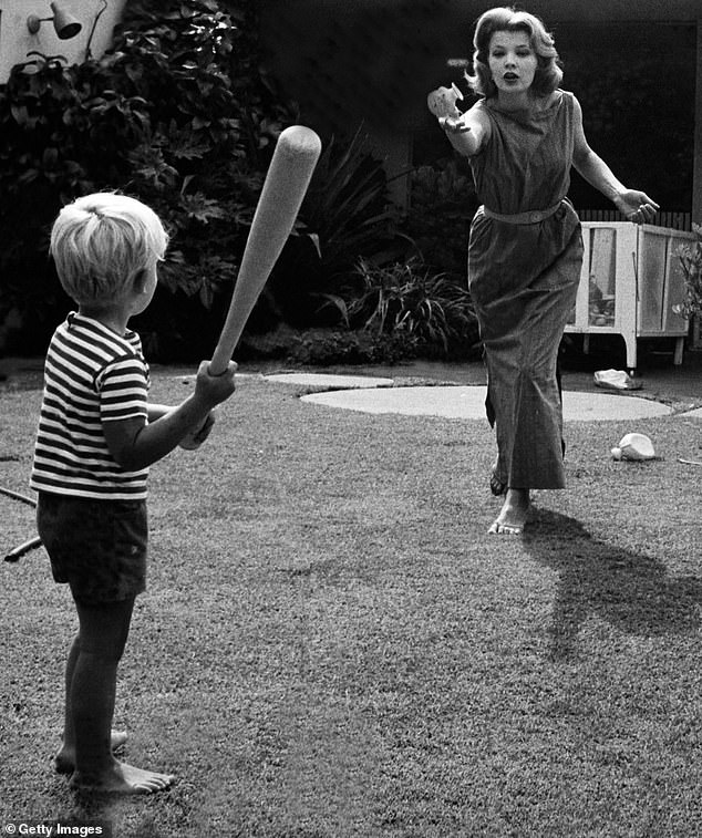 Pictured: Gena Rowlands playing baseball with her son Nick Cassavetes, who would eventually follow his father's place as principal, at their home in 1964, Los Angeles, California.