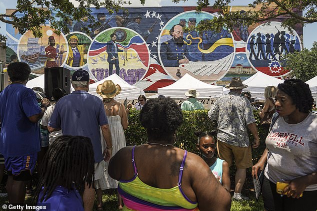 People gather to celebrate the unveiling of the mural as part of the Juneteenth Legacy Project commemorating the end of slavery in the United States on June 19 in Galveston, Texas.