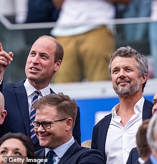 William points forward while chatting with his fellow best man, Frederick of Denmark. They both look mature and sophisticated in their navy blue suits.