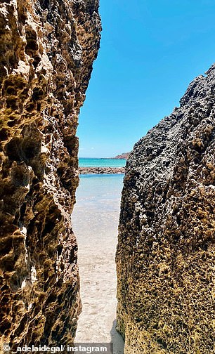 Upon reaching Stokes Bay, visitors navigate a maze-like rock passage before emerging onto sun-drenched sands and water. 