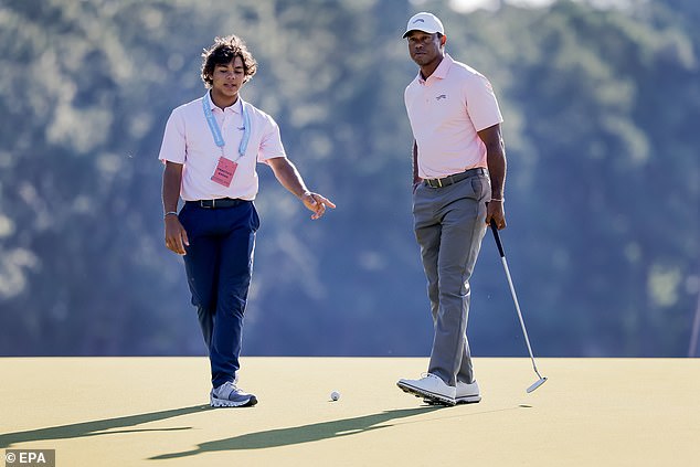 Charlie Woods, 15, gives some advice to his legendary father Tiger at Pinehurst on Tuesday