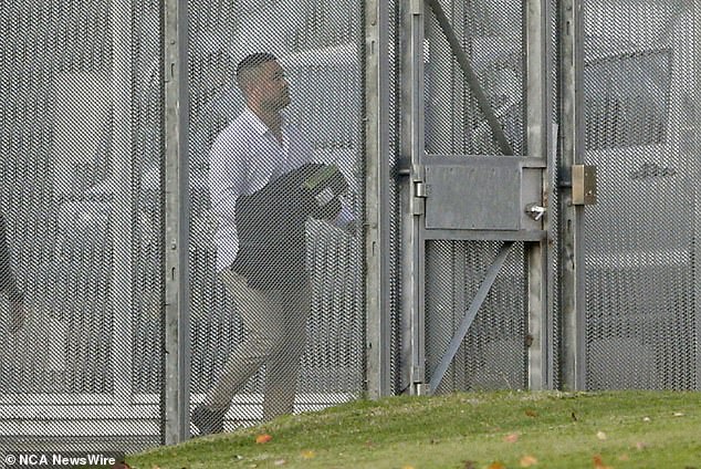 Dressed in an untucked white shirt, tan chinos and clutching a few belongings, Hayne briefly looked up at the sky before hugging one of his family members Wednesday night as he walked out of the gates of the Mary Wade Correctional Center. after their rape convictions were sensationally overturned (pictured). )