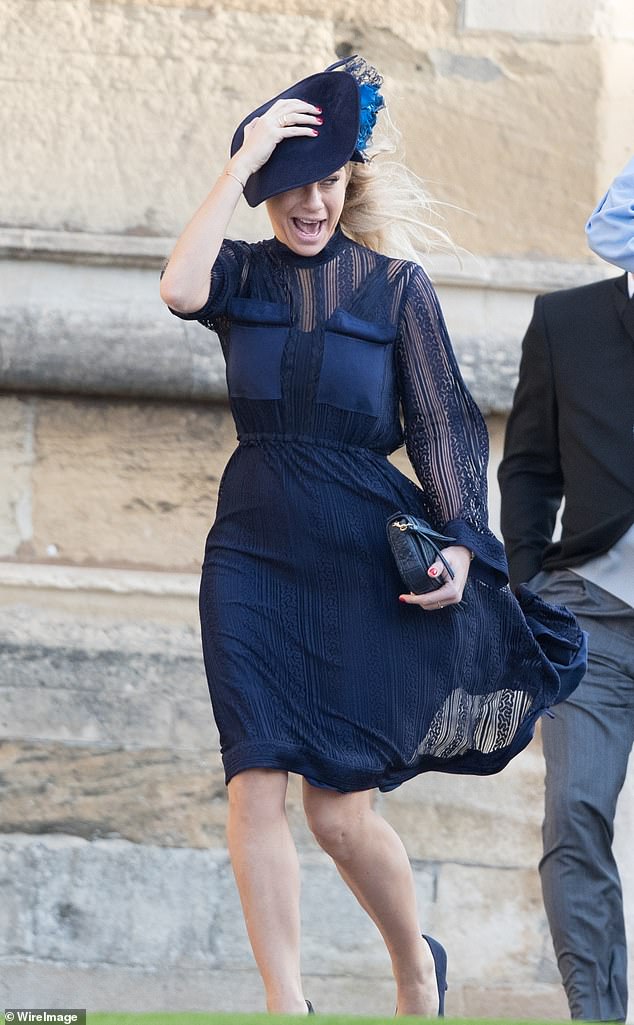 Chelsy Davy screams in the windy weather as she arrives at St George's Chapel for the wedding of Princess Eugenie and Jack Brooksbank.