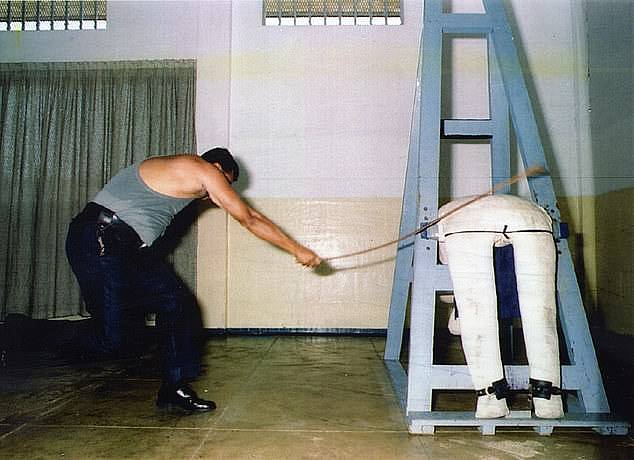 If convicted, he could face 12 lashes. Pictured is a prison officer at Singapore's Changi Prison demonstrating how to whip a mannequin.