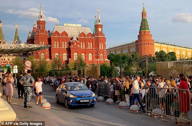 Fans wait for Kanye West at the Four Seasons Hotel in central Moscow, where the American rapper is believed to be staying.