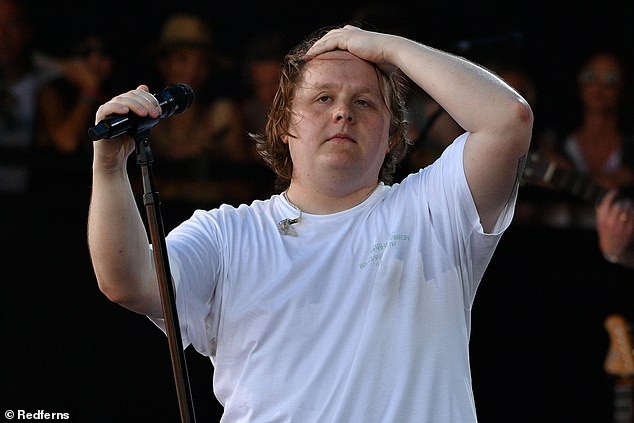 In a very moving moment during his performance at Glastonbury a year ago, Lewis struggled to sing due to Tourette's symptoms, but the dedicated crowd of fans rallied to continue singing Someone You Love for him, marking a very remarkable moment (pictured a year ago).