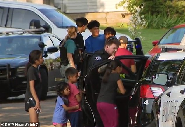 Four of the victims were children between the ages of 3 and 10 and three were adults, said state troopers, who chose not to name those affected as some are recovering from non-life-threatening injuries in local hospitals. A group of people are seen outside the house on Friday.